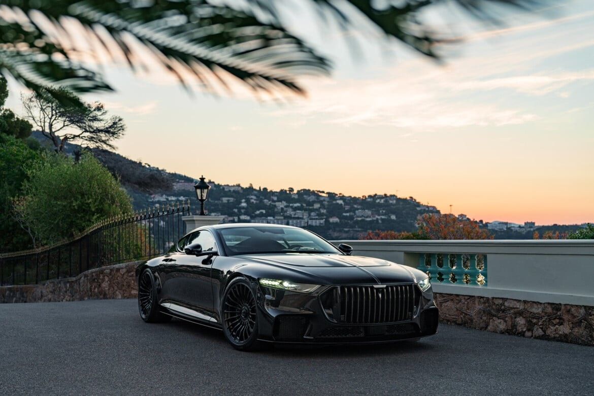 Black BRABUS coupe on a terrace above the Monaco coast at sunset. BRABUS automotive imagery, not the residential project.
